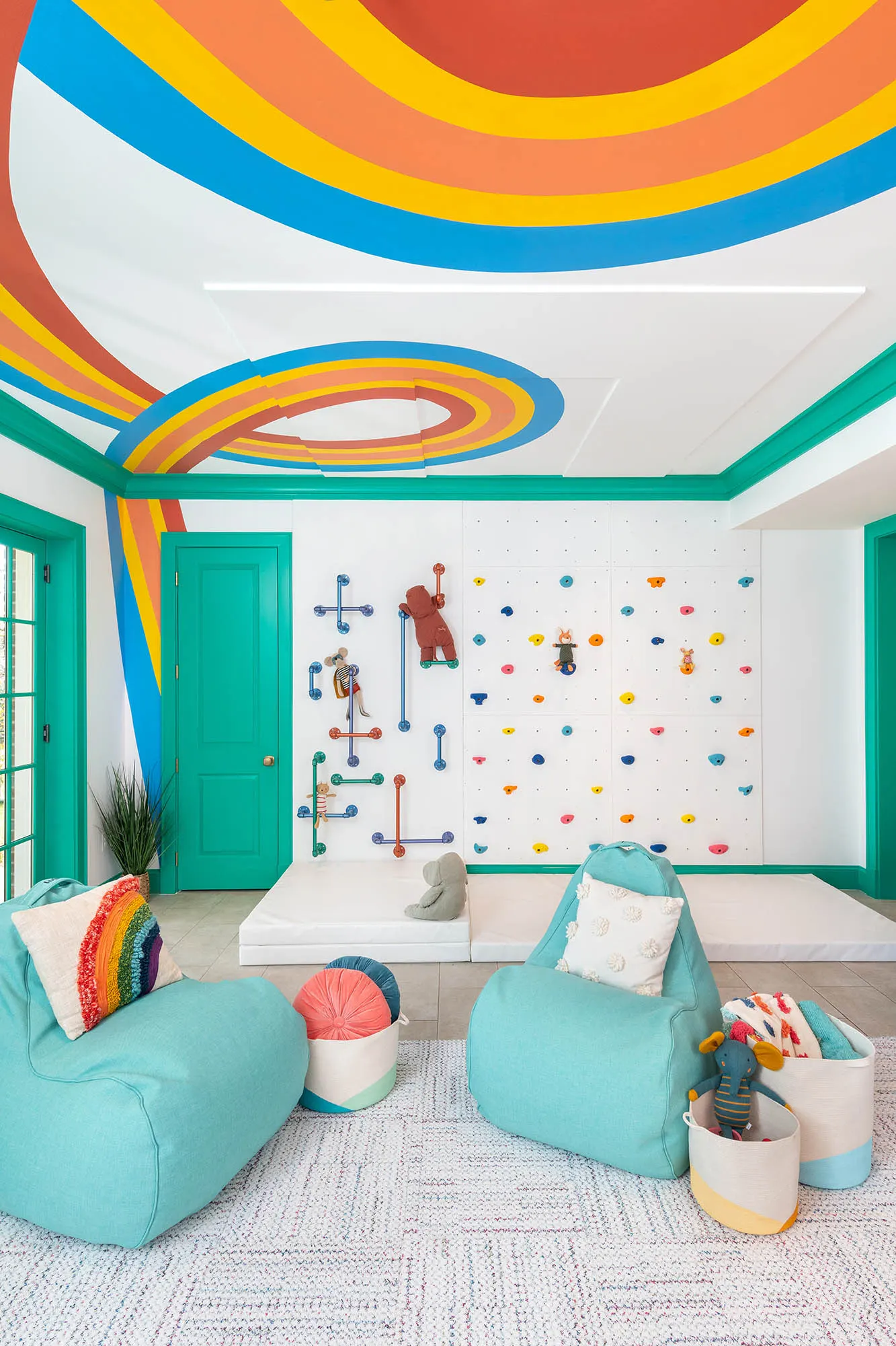 Continuous ceiling ribbon turning down the wall beside a climbing area