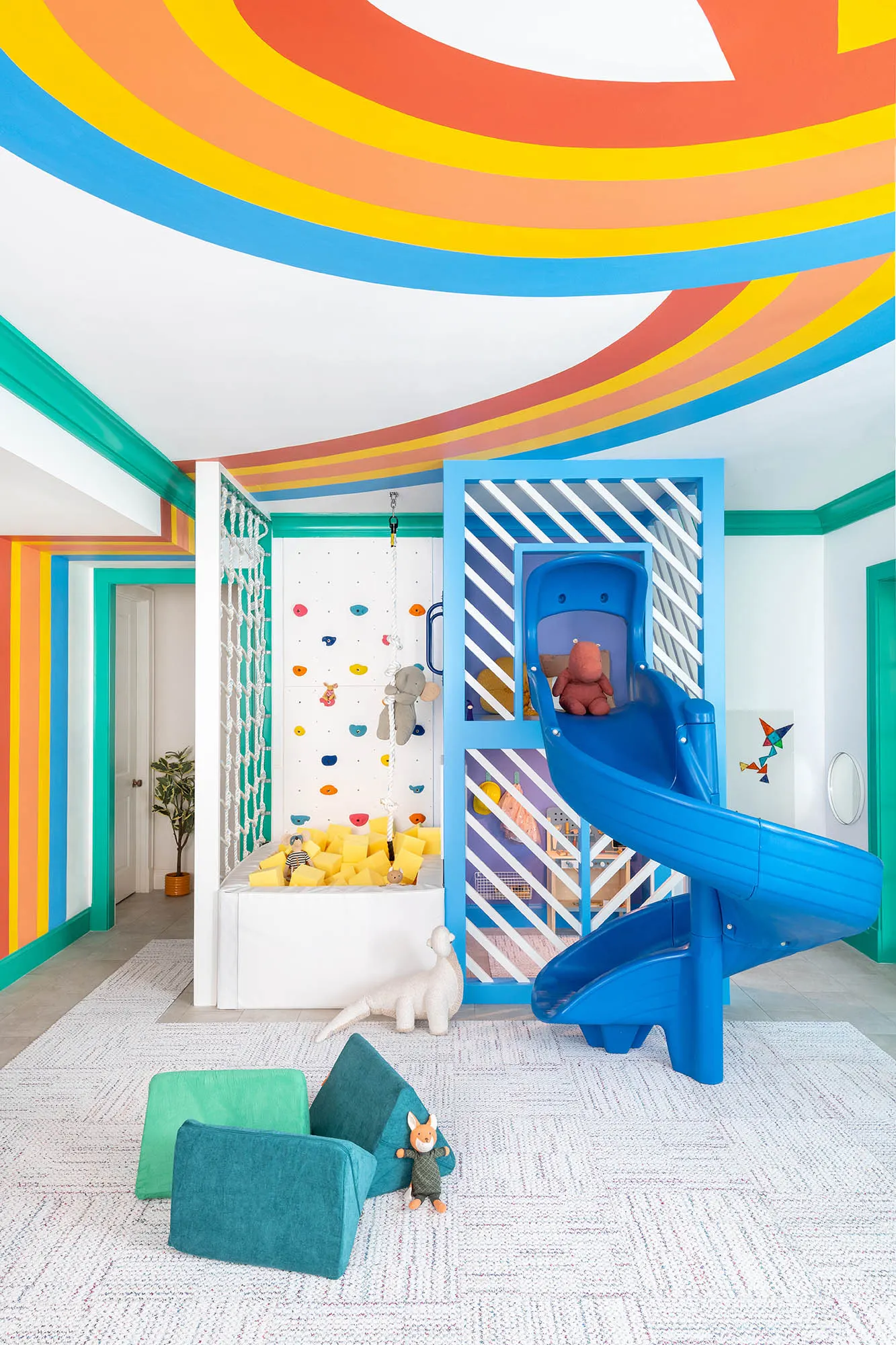 Ribbon mural connecting the ceiling, doorway, and play structure