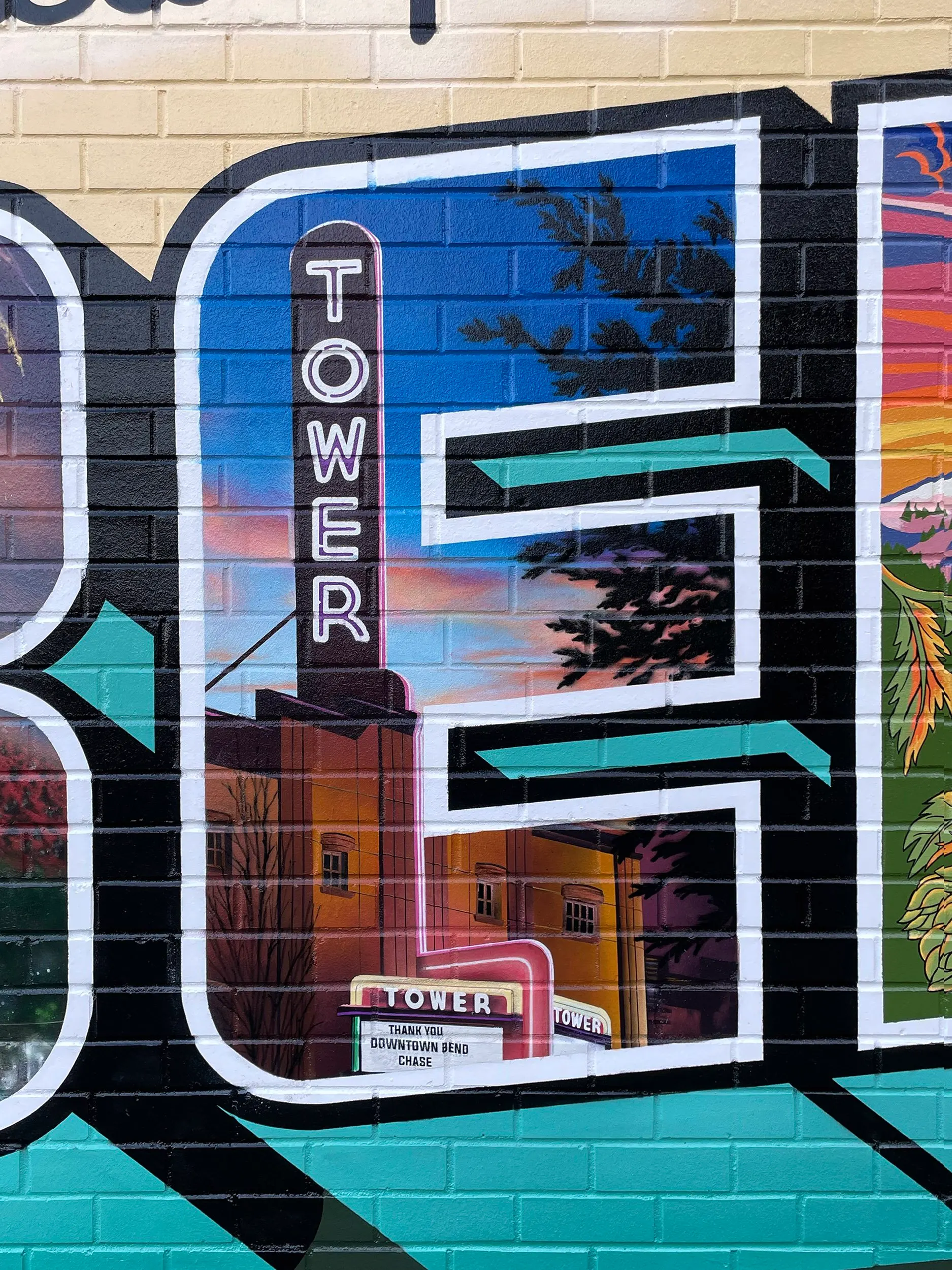 Tower Theatre and downtown Bend details painted inside the letter E