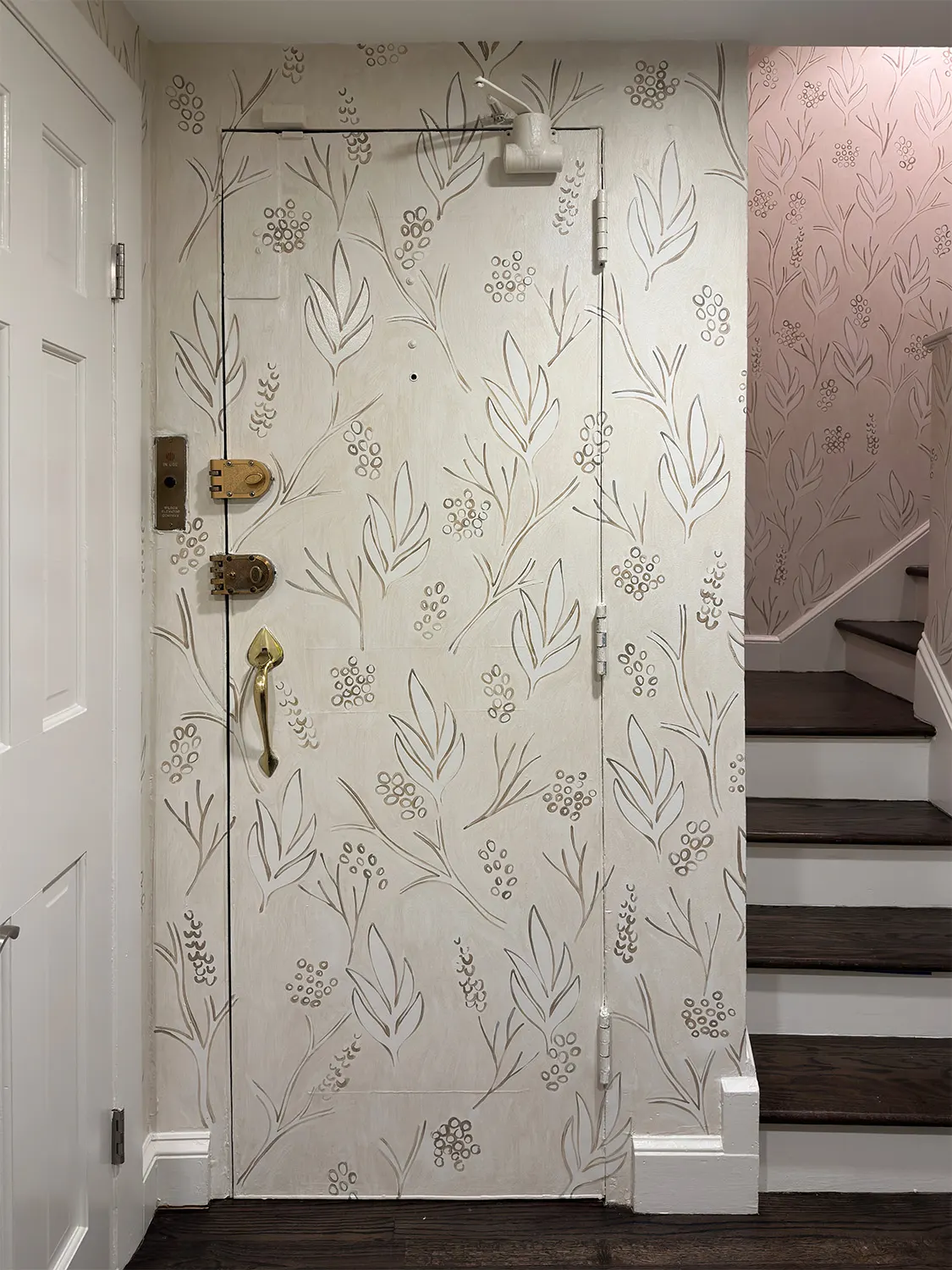 Entry and staircase wrapped in a pale hand-painted botanical pattern in a Beacon Hill home