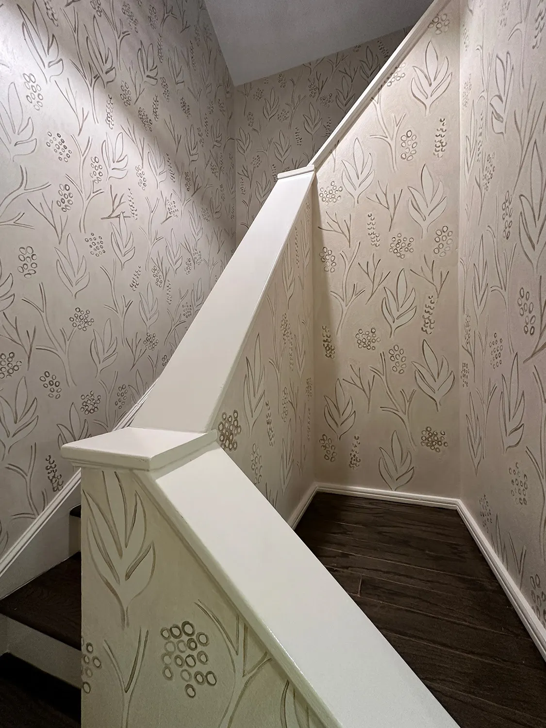 Botanical mural continuing around the landing and stairwell walls