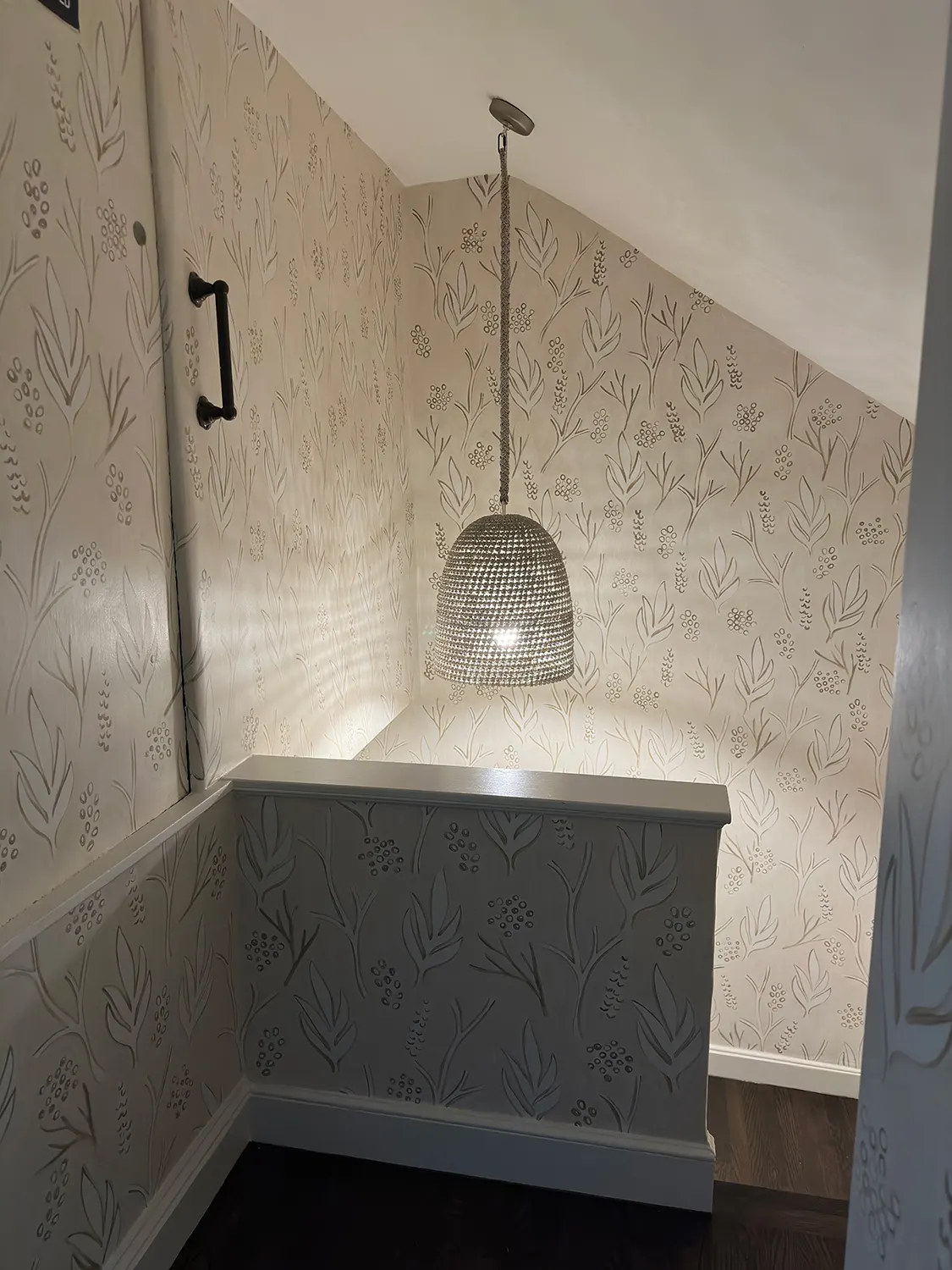 Botanical mural surrounding a stair landing and pendant light