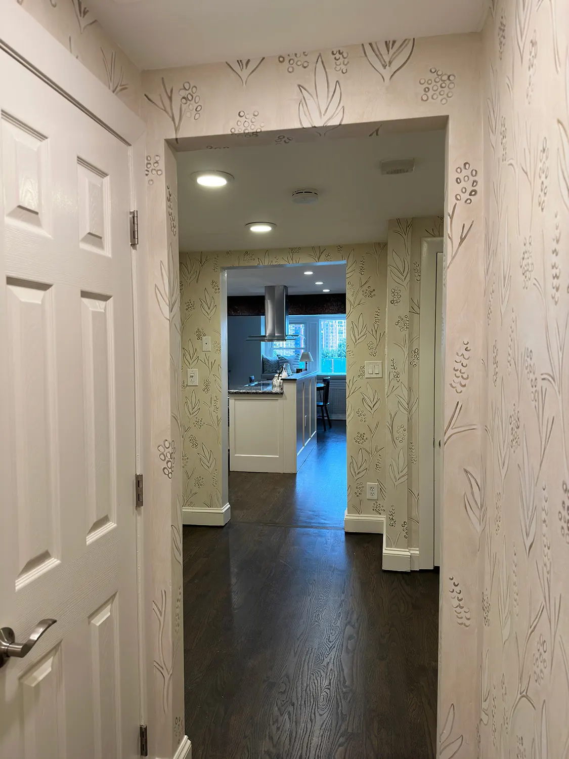 View through the hallway showing the botanical mural across adjoining walls