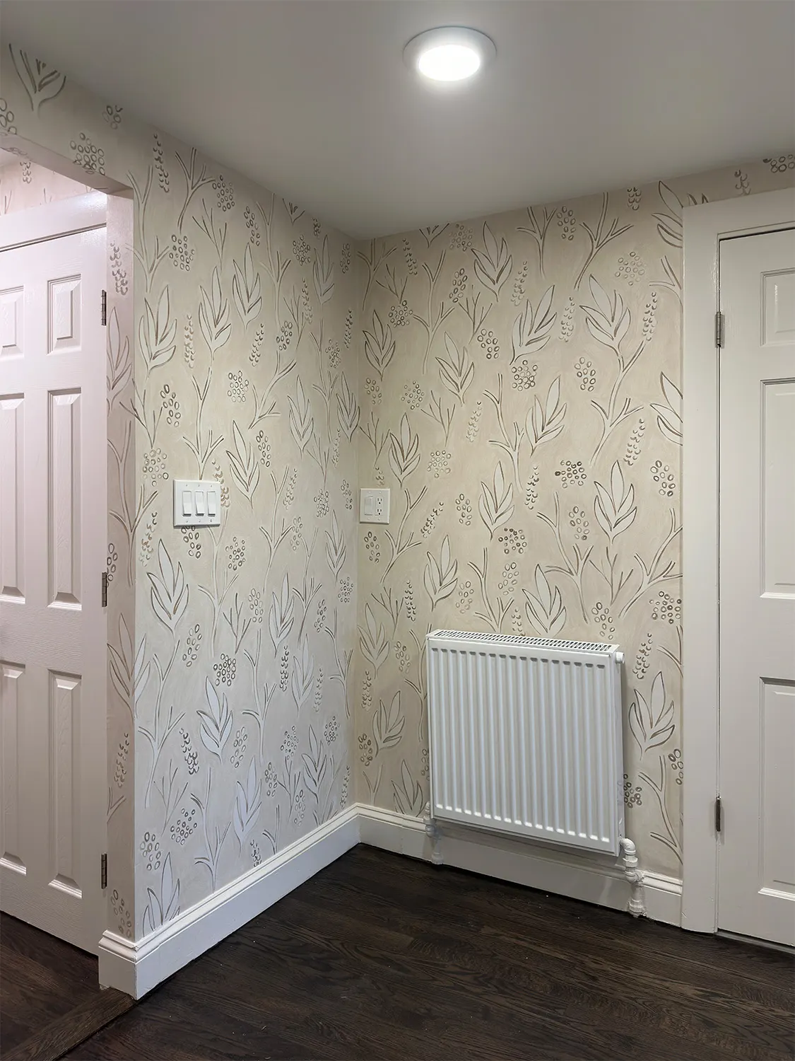 Finished botanical mural beside a radiator and doorway in the Beacon Hill home