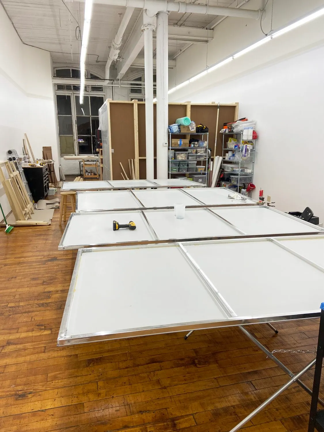Backs of the portable mural panels laid out for fabrication in the studio