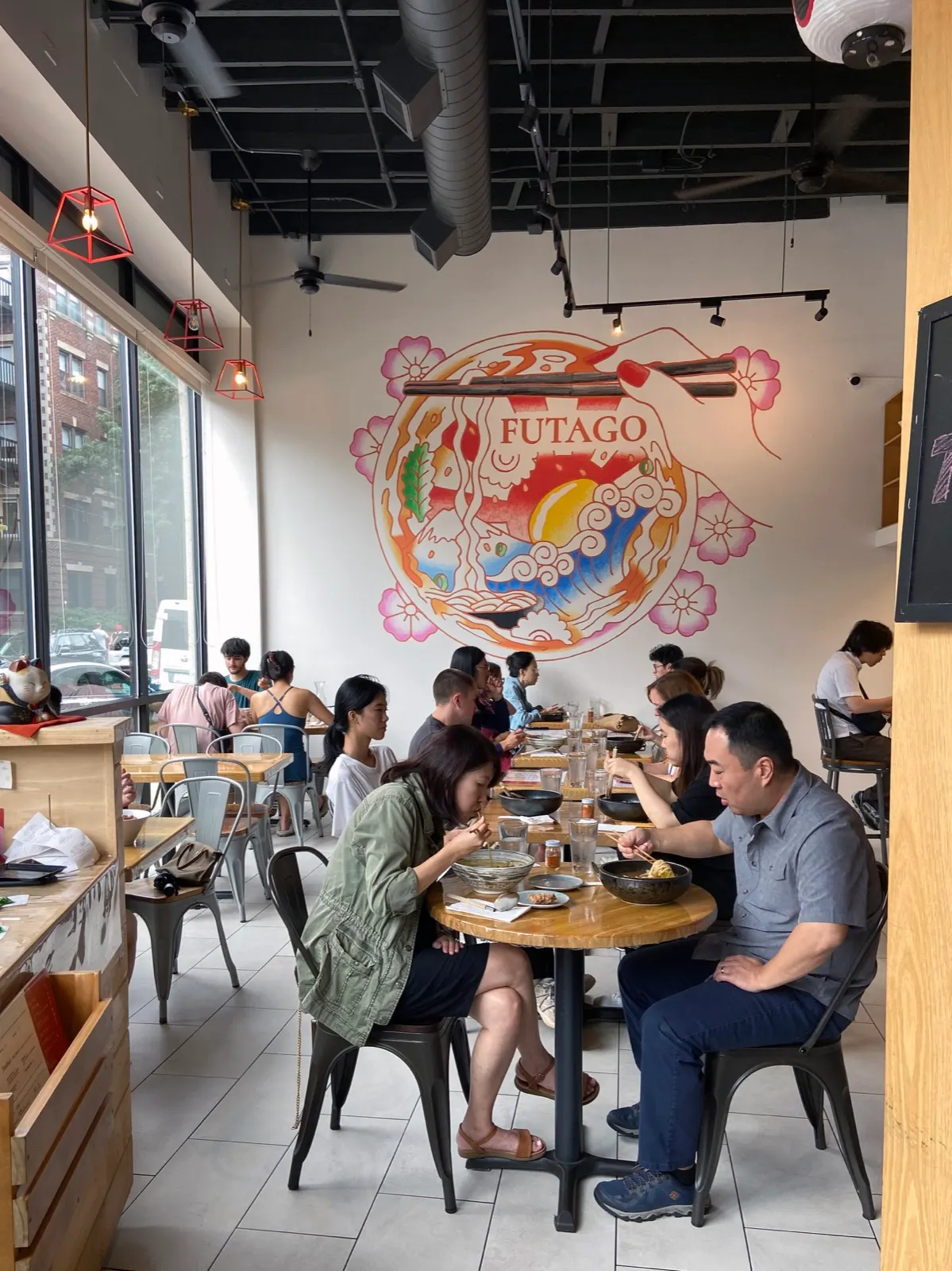 Busy Futago Udon dining room with the finished bowl and Mount Fuji mural