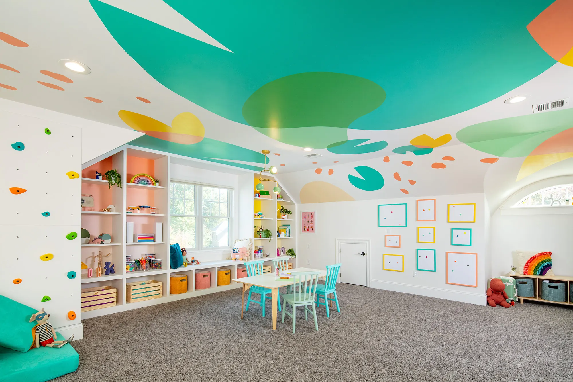 Needham playroom with a large abstract mural flowing across the ceiling