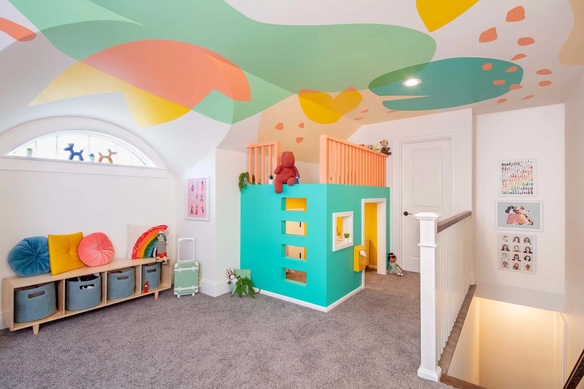 Abstract ceiling mural continuing over a reading nook and stair opening