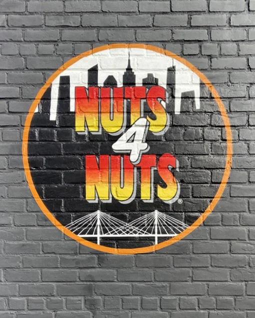 Finished hand-painted Nuts4Nuts sign on gray brick at the company's Astoria headquarters