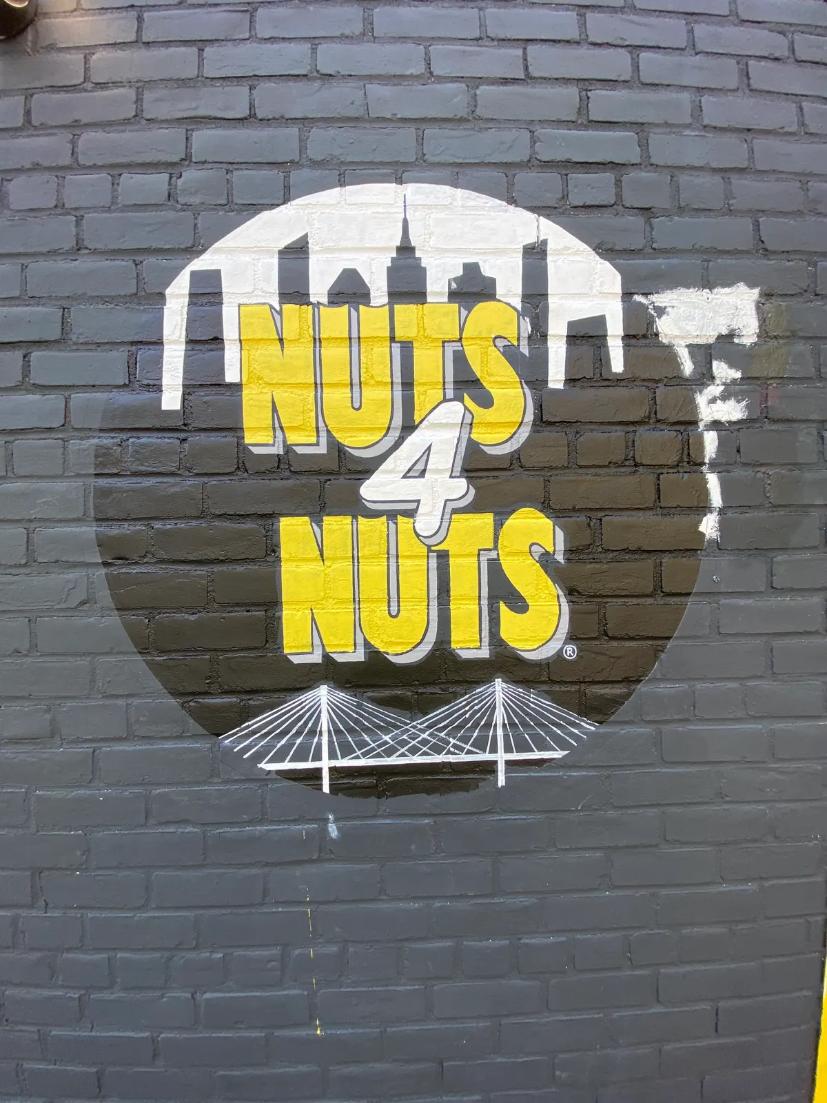 Nuts4Nuts sign in progress with the skyline, lettering, and Queensboro Bridge blocked in