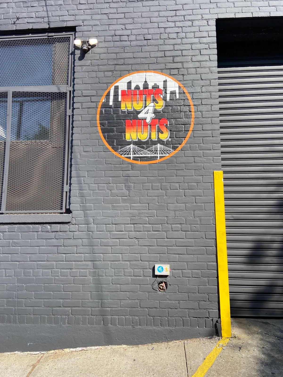 Wide view of the finished Nuts4Nuts sign beside the headquarters loading bay