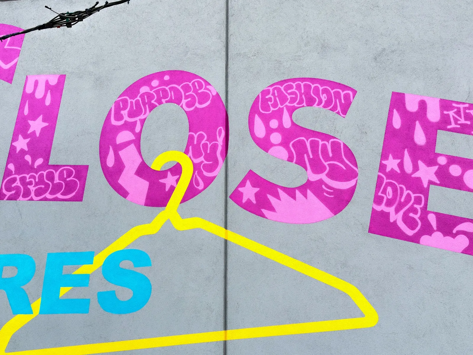 Finished Closet lettering filled with layered pink graffiti above a yellow hanger and turquoise Stores text