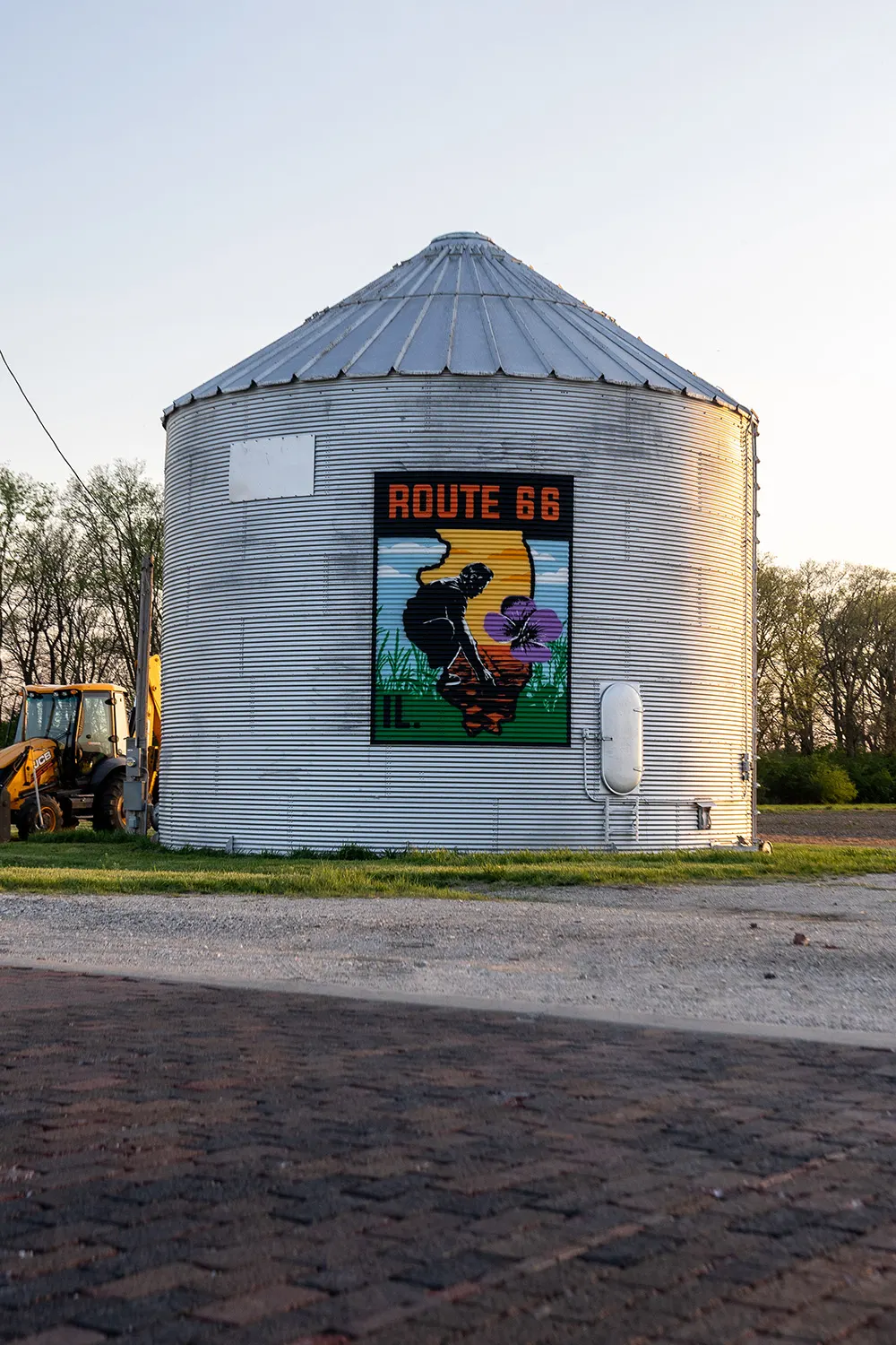 Route 66 mural on the silo beside the historic brick road
