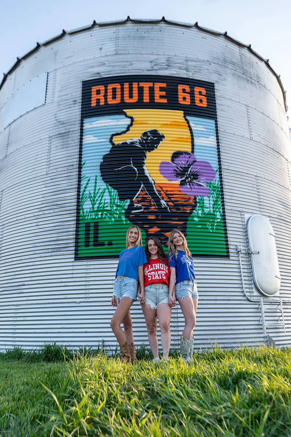 Two visitors posing in front of the completed silo mural