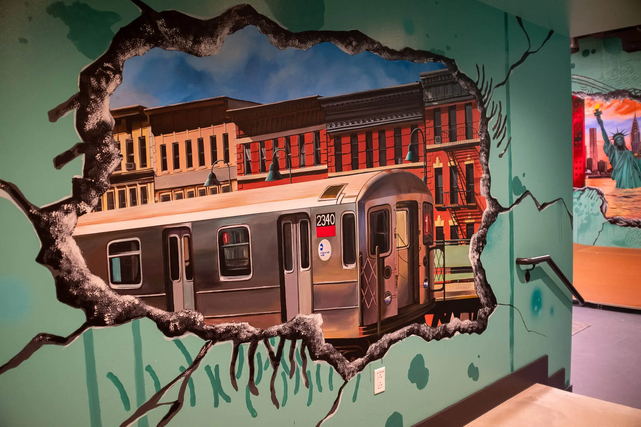 Elevated subway train painted inside a broken-wall opening