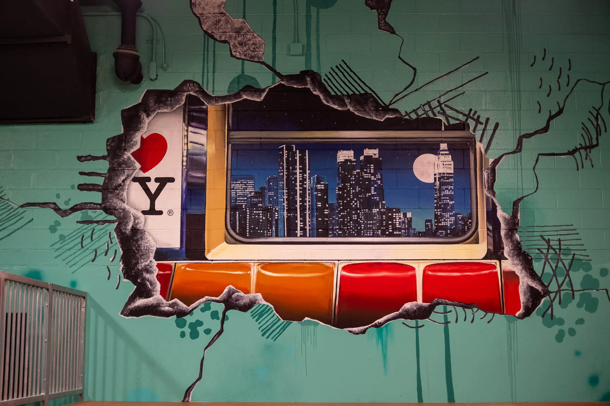 Close view of the subway windows and night skyline mural