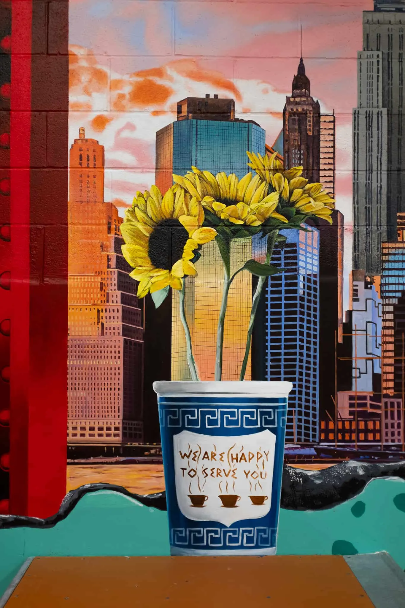 Sunflowers in an Anthora coffee cup against the Manhattan skyline
