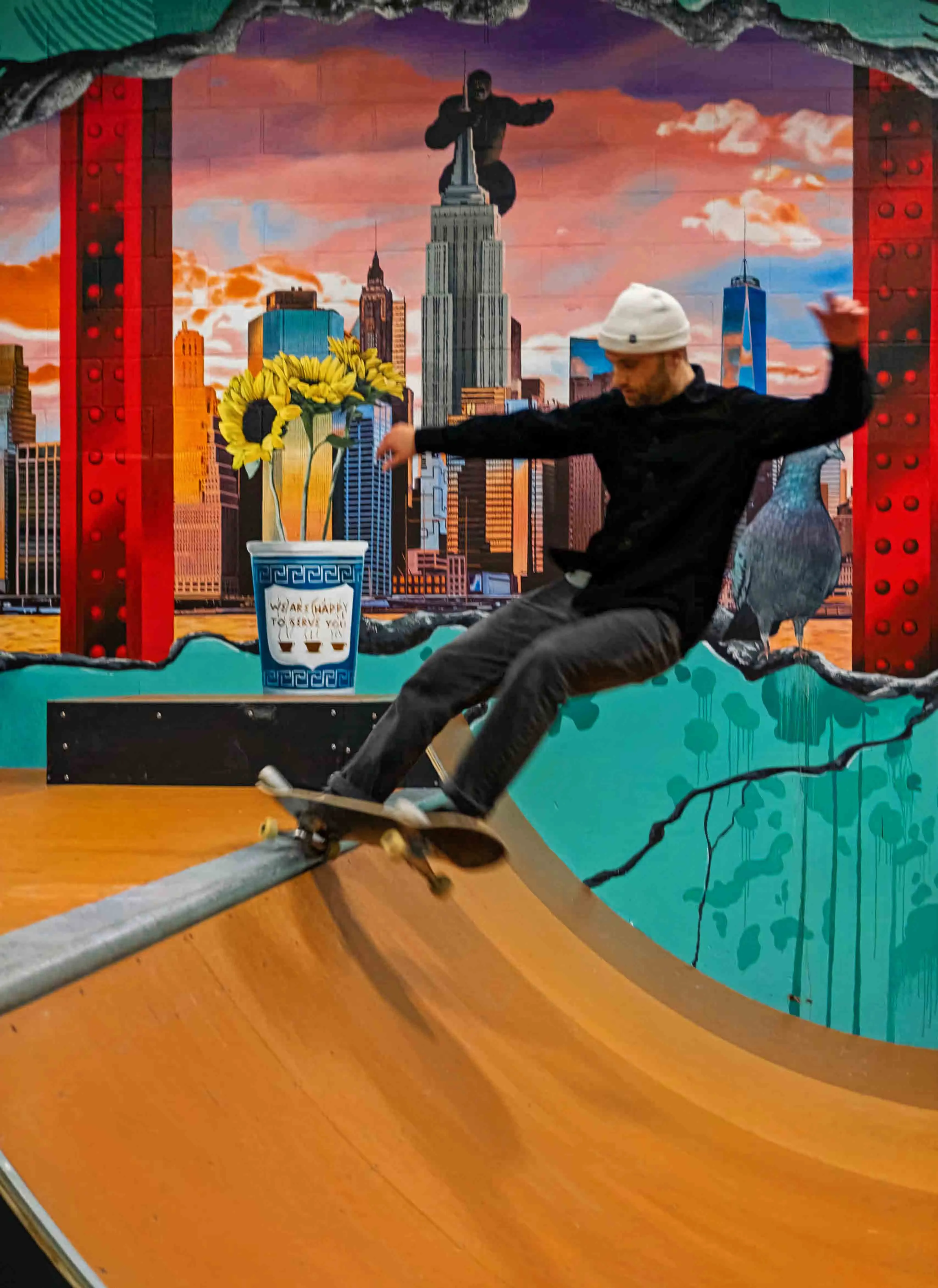 Skater riding the ramp in front of the finished New York panorama