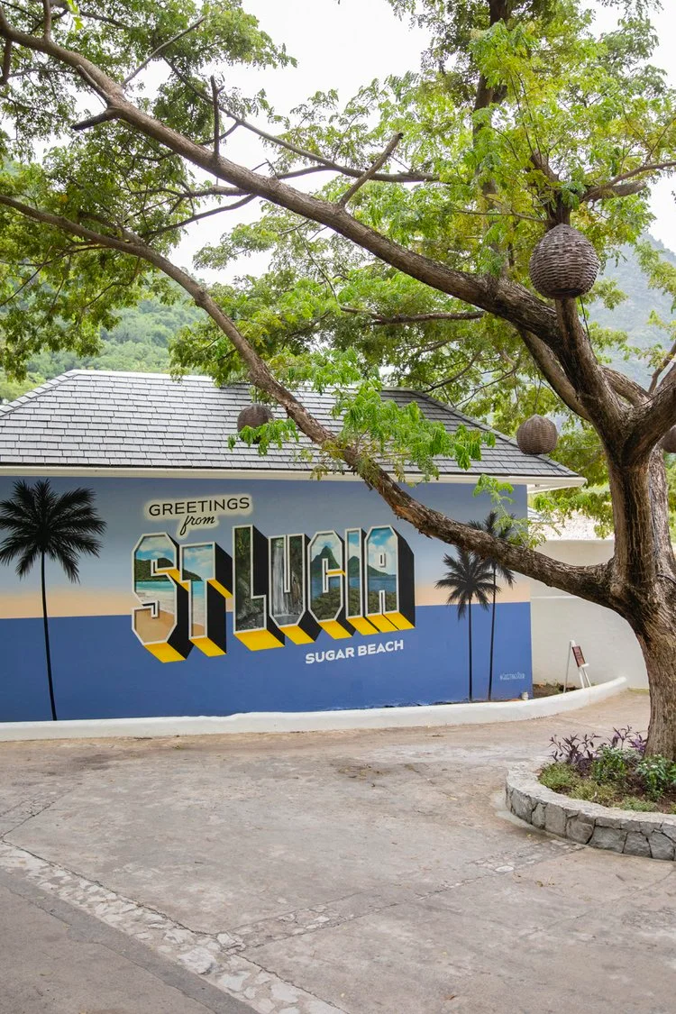 Finished St. Lucia mural seen along the tree-lined resort path