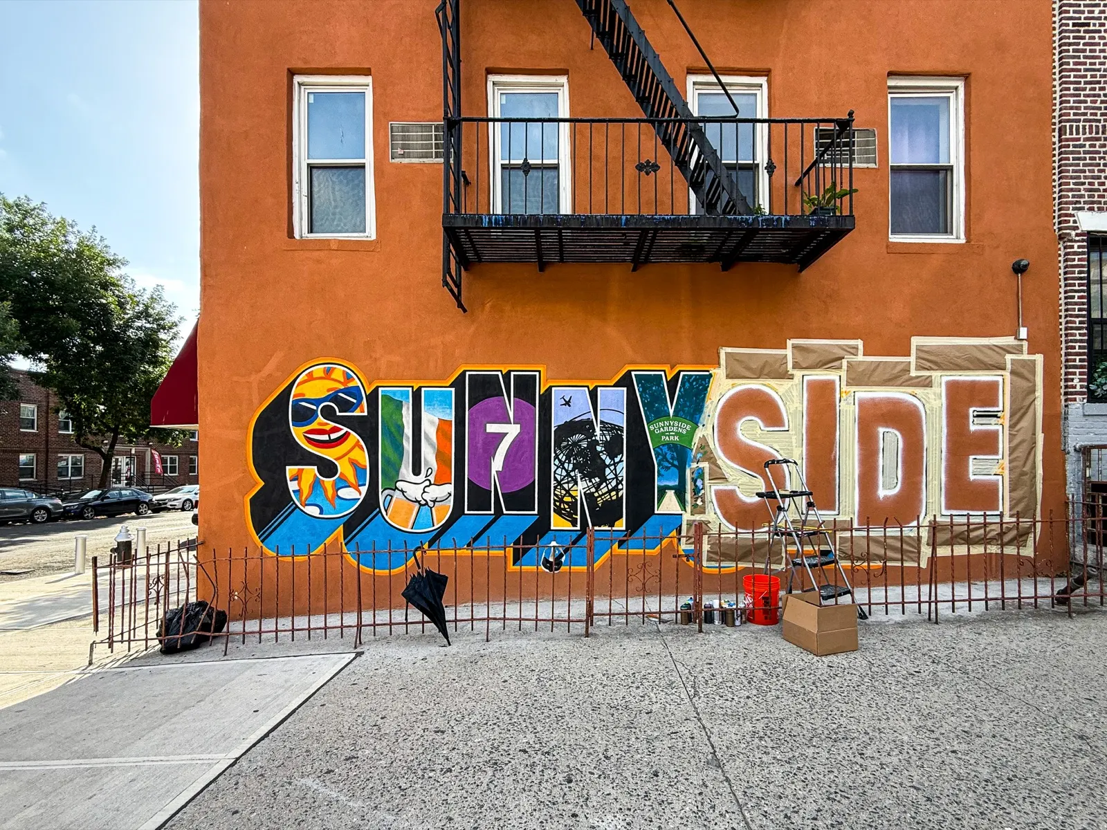 Wide daylight work-in-progress view with finished scenes on the left and masked letters on the right
