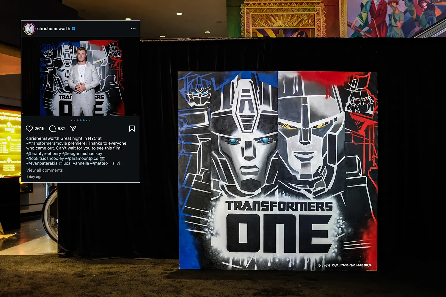 Hand-painted Transformers One backdrop installed beside a premiere display