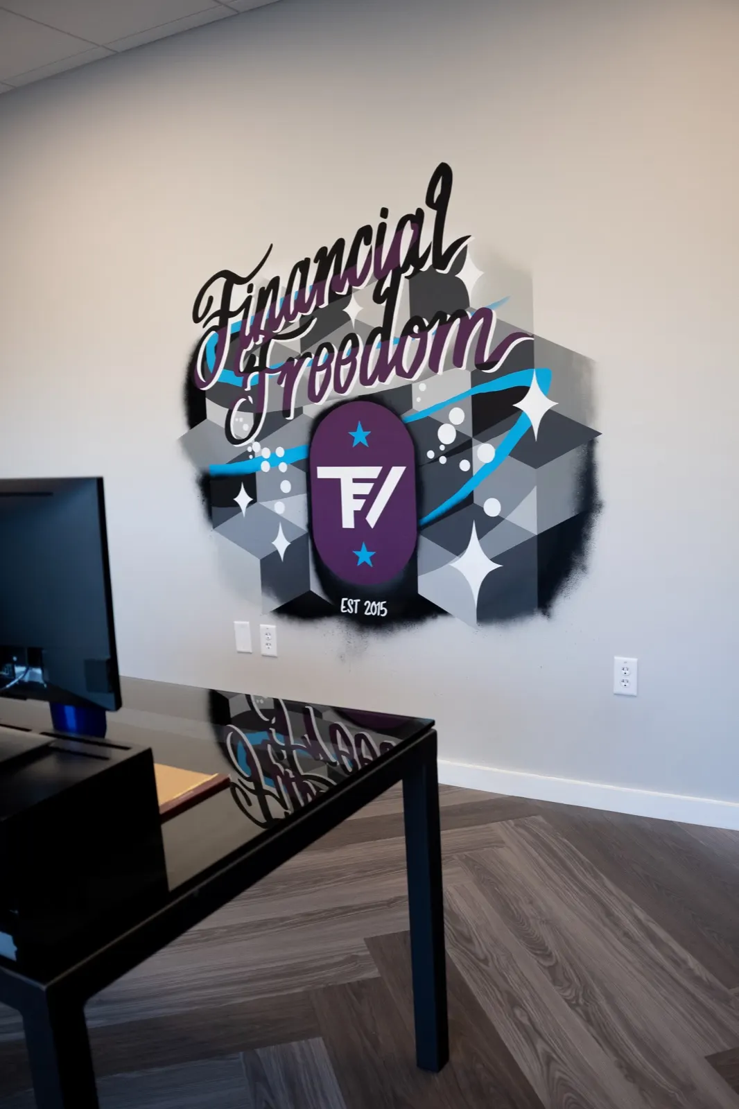 Vertical view of the TrueView Financial lobby mural above a glossy black table