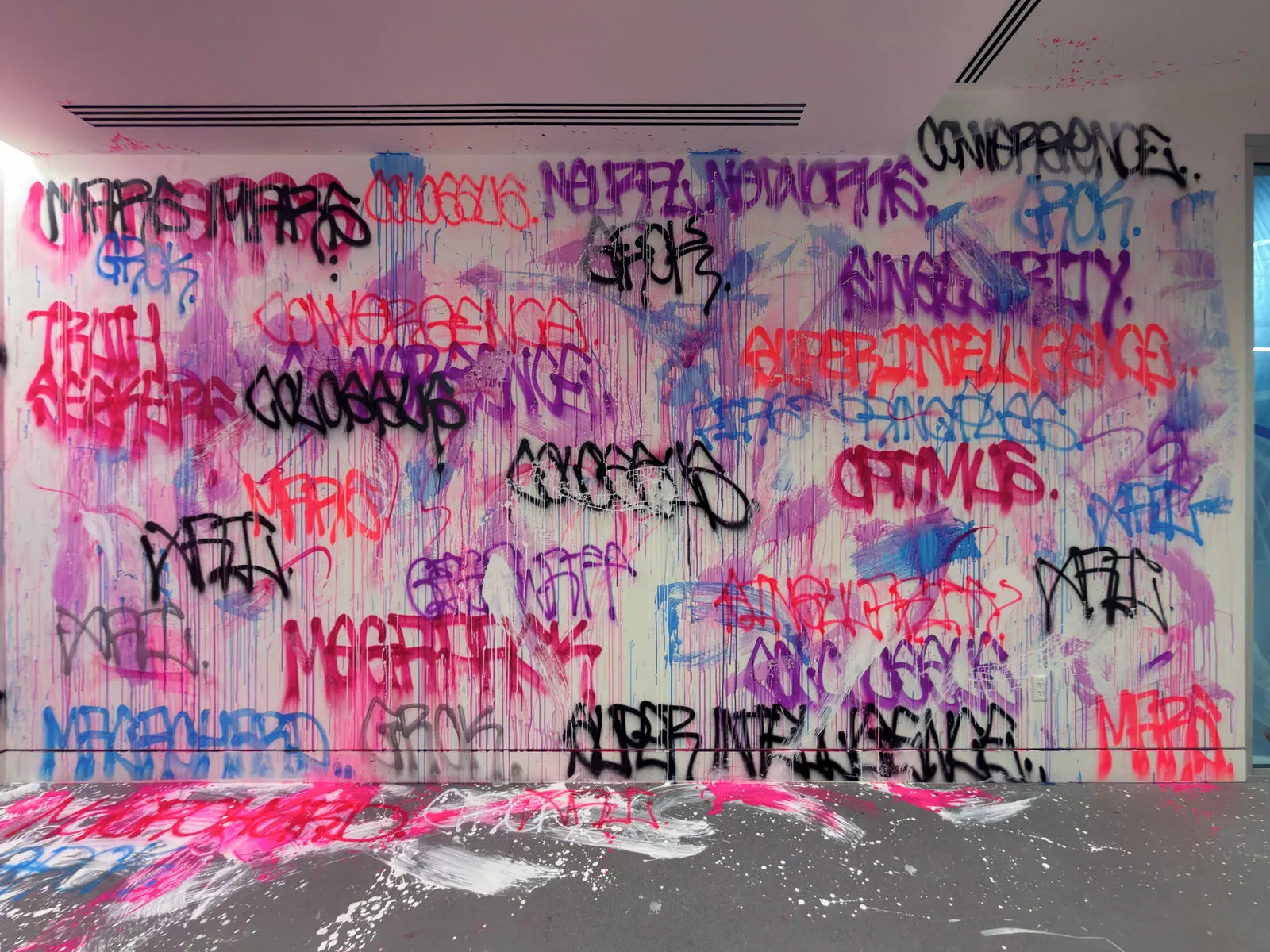 Wide tagged wall at the xAI office with overlapping brand-related words